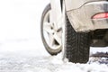 Close-up of car wheel in winter tire on snowy road Royalty Free Stock Photo