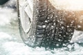 Close-up of car wheel in winter tire on snowy road Royalty Free Stock Photo