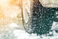 Close-up of car wheel in winter tire on snowy road