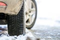 Close-up of car wheel in winter tire on snowy road Royalty Free Stock Photo