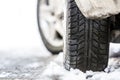 Close-up of car wheel in winter tire on snowy road Royalty Free Stock Photo