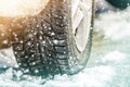 Close-up of car wheel in winter tire on snowy road Royalty Free Stock Photo