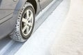 Close-up of car wheels rubber tire in deep snow. Transportation and safety concept Royalty Free Stock Photo