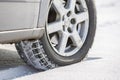 Close-up of car wheels rubber tire in deep snow. Transportation and safety concept Royalty Free Stock Photo