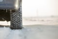 Close-up of car wheels rubber tire in deep snow. Transportation and safety concept