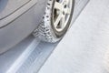 Close-up of car wheels rubber tire in deep snow. Transportation and safety concept