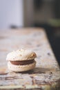 Close up of caramel coffee macaroon on rustic tabletop