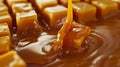 Close-up of caramel cubes in the shape of a pyramid along which liquid caramel flows