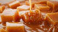 Close-up of caramel cubes in the shape of a pyramid along which liquid caramel flows.