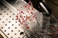 Close-up of caramel strands with pink flower petals as glass decoration