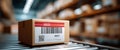 Close-up of a cardboard box with barcode and QR code on conveyor belt in a large warehouse storage facility Royalty Free Stock Photo