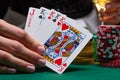 Close-up cards for playing poker on a gaming table in a casino against a background of chips. Background for a gaming business Royalty Free Stock Photo