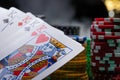 Close-up cards for playing poker on a gaming table in a casino against a background of chips. Background for a gaming business Royalty Free Stock Photo