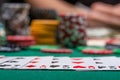 Close-up cards for playing poker on a gaming table in a casino against a background of chips. Background for a gaming business Royalty Free Stock Photo