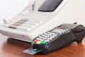 Close-up of cards servicing with POS-terminal on the cash regist Royalty Free Stock Photo