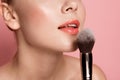 Female lips and rouge paintbrush Royalty Free Stock Photo