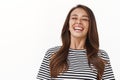 Close-up carefree enthusiastic gorgeous tanned woman with freckles in striped t-shirt laughing, close eyes and smiling