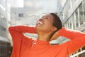 Close up carefree young african american woman with hands behind head Royalty Free Stock Photo