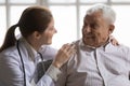 Close up caring female doctor talking to smiling older man