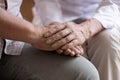 Close up of caring female nurse support male senior patient