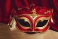 Close-up carnival mask, theatrical background.