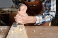 Close up of a Carpenter carving wood with chisel