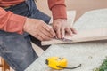 Close up carpenter dirty hands working with ruler and pencil