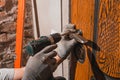 Close-up, the carpenter installs a custom lock in the front metal door, using a drill and hammer and other tools Royalty Free Stock Photo