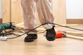 carpenter legs stumbling with an electrical cord