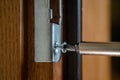 Close up of carpenter repairing door lock. Installing a door handle. Handyman tightening door hinge . Hands of the repairman with Royalty Free Stock Photo