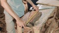 Close up carpenter`s hand measuring wood using carpenters ribbon ruler