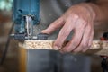 Close-up process of cutting wood board with jigsaw