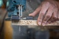 Close-up process of cutting wood board with jigsaw