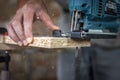 Close-up process of cutting wood board with jigsaw