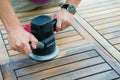 Close-up of carpenter`s hands working with electric sander Royalty Free Stock Photo