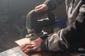 Close up of carpenter`s hands working power tools for processing wood. Power Jigsaw