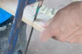 Close up of Carpenter sawing a board with a hand wood saw Royalty Free Stock Photo