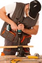 Close up of a carpenter screwed a hinge on a wooden plank Royalty Free Stock Photo