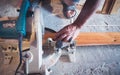 Close-up of a carpenter using a circular saw to cut a large board of wood Royalty Free Stock Photo