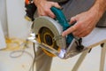 Close-up of carpenter using a circular saw to cut a large board of wood Royalty Free Stock Photo