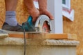 Close-up of a carpenter using a circular saw to cut a large board of wood Royalty Free Stock Photo