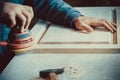 carpenter using sander for wood furniture