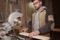 Close-up of a carpenter doing woodwork. a small business owner was cutting a wooden Board with a circular saw in a workshop