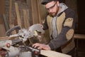 Close-up of a carpenter doing woodwork. a small business owner was cutting a wooden Board with a circular saw in a workshop