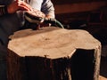 Close-up of a carpenter working with an electric grinder. wood stump processing Royalty Free Stock Photo