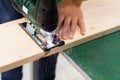 Close-up carpenter working with an electric jigsaw