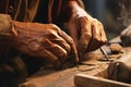 close-up of a carpenters hands shaping a wooden part of a ship