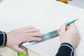 Close up Carpentry, mans hand using tape measure to measure wood plank and marking it with pencil. view from above Royalty Free Stock Photo