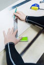 Close up Carpentry, mans hand using tape measure to measure wood plank and marking it with pencil. view from above Royalty Free Stock Photo