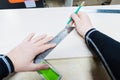 Close up Carpentry, mans hand using tape measure to measure wood plank and marking it with pencil. view from above Royalty Free Stock Photo